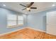 Light blue bedroom with hardwood floors and ceiling fan at 1902 Canterbury St, Decatur, GA 30032