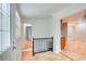 Hardwood floors, simple railing, and open concept to living and dining areas at 1902 Canterbury St, Decatur, GA 30032