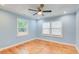 Light blue bedroom with hardwood floors and two windows at 1902 Canterbury St, Decatur, GA 30032