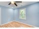 Light blue bedroom with hardwood floors and a window at 1902 Canterbury St, Decatur, GA 30032