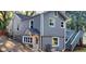Gray house with a wooden deck and stairs, a partial view of a fenced yard, and a driveway at 1902 Canterbury St, Decatur, GA 30032