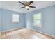Light blue bedroom with hardwood floors and ceiling fan at 1902 Canterbury St, Decatur, GA 30032