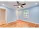 Light blue bedroom with hardwood floors and a closet at 1902 Canterbury St, Decatur, GA 30032