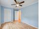 Bedroom with light blue walls, hardwood floors, and a ceiling fan at 1902 Canterbury St, Decatur, GA 30032
