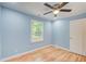Light blue bedroom with hardwood floors and a ceiling fan at 1902 Canterbury St, Decatur, GA 30032