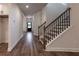 Elegant staircase with dark wood railing and hardwood floors at 1446 Red Oak Ln, Loganville, GA 30052