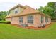 Brick house exterior with a dormer, landscaping, and large windows at 252 Madison Park Dr, Grayson, GA 30017