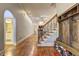 Hardwood floors, staircase, and built-in shoe storage at 252 Madison Park Dr, Grayson, GA 30017