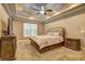Large main bedroom with carpeted floors and tray ceiling at 252 Madison Park Dr, Grayson, GA 30017