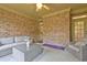 Relaxing sunroom with brick walls and plenty of natural light at 252 Madison Park Dr, Grayson, GA 30017