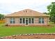 Brick house with a large sunroom and well-maintained lawn at 252 Madison Park Dr, Grayson, GA 30017
