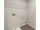 A utilitarian laundry area features a wire rack shelf and hookups for washer and dryer at 558 Abbott Se Ct, Atlanta, GA 30354