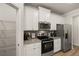 Modern kitchen with stainless steel appliances and ample cabinetry at 558 Abbott Se Ct, Atlanta, GA 30354