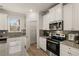Modern kitchen with stainless steel appliances and granite countertops at 558 Abbott Se Ct, Atlanta, GA 30354
