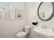 Powder room featuring a pedestal sink and oval mirror at 558 Abbott Se Ct, Atlanta, GA 30354