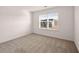 Well-lit bedroom with carpeted floor and a window at 3219 Champions Way, Loganville, GA 30052