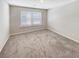 Bright bedroom with neutral carpeting and large window at 2286 Foley Park St, Snellville, GA 30078