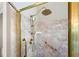 Walk-in shower with marble tile and gold fixtures at 761 Hardage Farm Nw Dr, Marietta, GA 30064