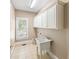 Laundry room with utility sink and ample cabinet storage at 761 Hardage Farm Nw Dr, Marietta, GA 30064