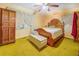 Bright bedroom featuring a wooden bed frame and yellow carpeting at 500 Cochran Rd, Covington, GA 30014