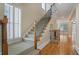 Elegant staircase with wrought iron railing and hardwood floors at 4740 Legacy Cove Ln, Mableton, GA 30126