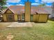 House exterior showcasing yellow siding, brown roof, and patio at 421 Thornbush Trce, Lawrenceville, GA 30046
