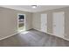 Spacious bedroom with large window, wall-to-wall carpet, and double closets at 421 Thornbush Trce, Lawrenceville, GA 30046