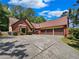 Brick house with three-car garage and driveway at 421 Thornbush Trce, Lawrenceville, GA 30046
