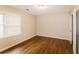 Simple bedroom with wood-look flooring, window, and closet at 2848 Creekwood Dr, Snellville, GA 30078