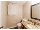 Clean bathroom with granite countertop and a framed mirror at 2848 Creekwood Dr, Snellville, GA 30078