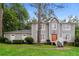 Two-story house with gray siding, a brick foundation, and a landscaped yard at 2848 Creekwood Dr, Snellville, GA 30078