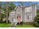 Two-story house with gray siding, a brick foundation, and a landscaped yard at 2848 Creekwood Dr, Snellville, GA 30078