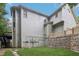 Side view of a home featuring gray siding, a stone retaining wall, and a well-manicured lawn at 5180 Ivy Green Se Way, Mableton, GA 30126