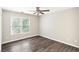 Well-lit bedroom with wood-look floors and large window at 5180 Ivy Green Se Way, Mableton, GA 30126