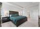 Large main bedroom with a dark wood bed frame, teal bedding, and carpeted floors at 220 Arwen Dr, Mcdonough, GA 30253