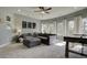 Game room with sectional sofa, air hockey table, and large windows at 557 Saltbox Ln, Mcdonough, GA 30252