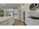Modern kitchen with white cabinets, stainless steel appliances and a large island at 557 Saltbox Ln, Mcdonough, GA 30252