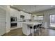 Elegant kitchen boasting white cabinets, large island, and stainless steel appliances at 557 Saltbox Ln, Mcdonough, GA 30252