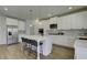 Modern kitchen featuring white cabinets, a large island, and stainless steel appliances at 557 Saltbox Ln, Mcdonough, GA 30252