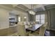 Formal dining room with chandelier, hardwood floors, and large art piece at 557 Saltbox Ln, Mcdonough, GA 30252