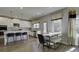 Modern kitchen with white cabinets, island, stainless steel appliances, and breakfast nook at 557 Saltbox Ln, Mcdonough, GA 30252