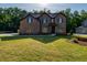 Brick two-story house with a covered front porch and landscaping at 557 Saltbox Ln, Mcdonough, GA 30252