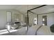 Main bedroom with four-poster bed and sitting area at 557 Saltbox Ln, Mcdonough, GA 30252