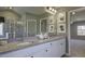Bathroom boasts granite countertops, double sinks, and a view into a bedroom at 557 Saltbox Ln, Mcdonough, GA 30252