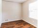 Simple bedroom with hardwood floors and large window at 2069 Chicago Nw Ave, Atlanta, GA 30314
