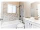 Clean bathroom with marble-tiled shower/tub and white vanity at 2069 Chicago Nw Ave, Atlanta, GA 30314