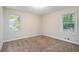Spacious bedroom with neutral walls and carpet, plus two windows at 2519 Brentwood Rd, Decatur, GA 30032