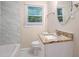 Bathroom with granite countertop, white vanity, and marble tile at 2519 Brentwood Rd, Decatur, GA 30032
