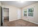 Bright bedroom with neutral walls and carpeting, plus a door to the hallway at 2519 Brentwood Rd, Decatur, GA 30032