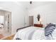 Spacious bedroom with hardwood floors, a metal bed frame, and access to another room at 1401 Whooping Creek Rd, Carrollton, GA 30116